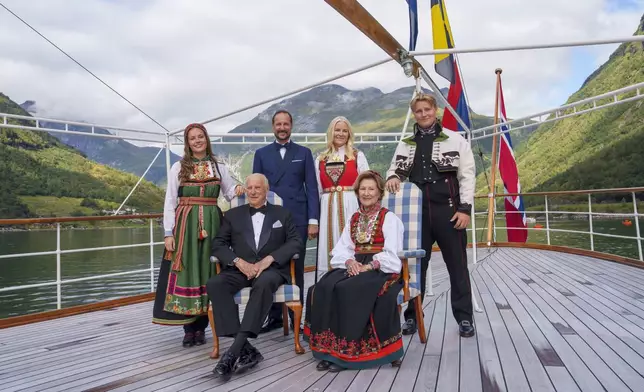 Norway's King Harald, Queen Sonja, front, Crown Prince Haakon, rear center left, Crown Princess Mette-Marit, rear center right, Princess Ingrid Alexandra and Prince Sverre Magnus aboard the Kingship Norway in the Geirangerfjord, Norway, Saturday Aug. 31, 2024, ahead of the wedding of Norway's Princess Martha Louise and Durek Verrett. (Cornelius Poppe/NTB via AP)