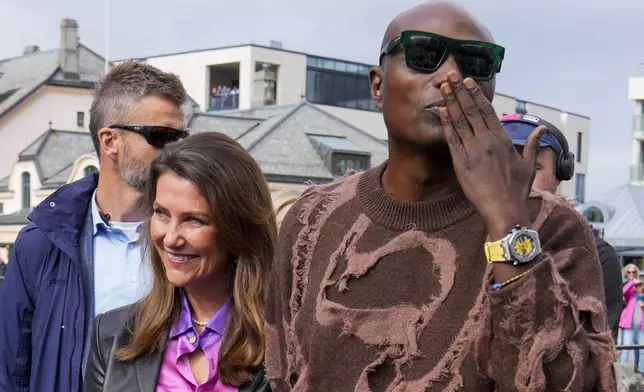 Norway's Princess Martha Louise and Durek Verret arrive at the boats in Alesund, Norway, Friday Aug. 30, 2024. that will transport them to Geiranger for their wedding celebration on Saturday. (Heiko Junge/NTB via AP)