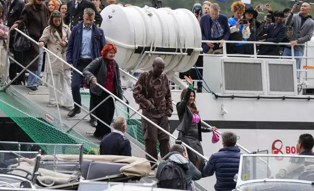 Norway's Princess Martha Louise, front, and Durek Verret, second, and guests arrive from Alesund to Geiranger, Norway, Friday Aug. 30, 2024, ahead of their wedding celebration on Saturday. (Cornelius Poppe/NTB via AP)