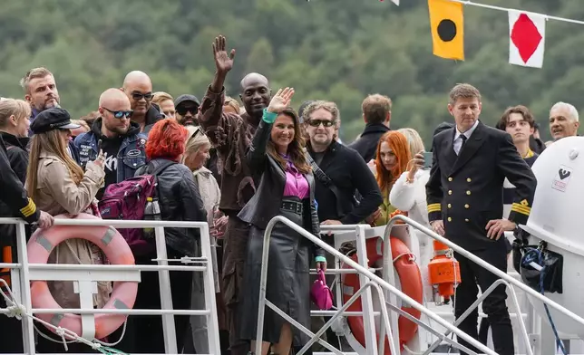 Norway's Princess Martha Louise, center, and Durek Verret, rear center, and guests arrive from Alesund to Geiranger, Norway, Friday Aug. 30, 2024, ahead of their wedding celebration on Saturday. (Cornelius Poppe/NTB via AP)