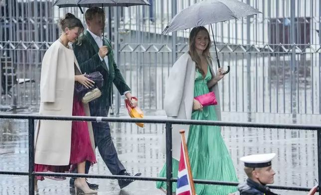 Norway's Princess Ingrid Alexandra, Prince Sverre Magnus and Amalie Giæver MacLeod walk on their way to a theme party at Hotel Union in Geiranger, Norway, on Friday, Aug. 30, 2024, the evening before the wedding ceremony of Princess Märtha Louise and Derek Verrett. (Cornelius Poppe/NTB Scanpix via AP)