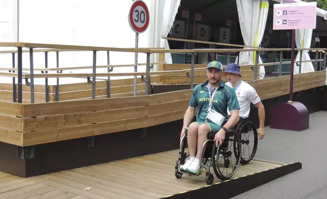 Two para-athletes in wheelchairs using a ramp in the Paralympic Village, Saturday, Aug. 24, 2024, in Saint-Ouen, France. (AP Photo/Tom Nouvian)