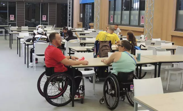 A room of the dining hall of the Paralympic village, ahead of the Paralympic Games, Saturday, Aug. 24, 2024 in Saint-Ouen, France. The organizers decided to remove some chairs to make extra room for wheelchair users. (AP Photo/Tom Nouvian)