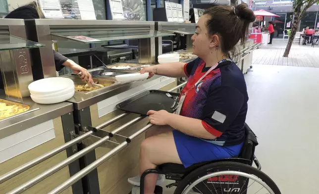 Chilean para-athlete Tamara Leonelli in the dining hall of the Paralympic village, ahead of the Paralympic Games, Saturday, Aug. 24, 2024 in Saint-Ouen, north of Paris. (AP Photo/Tom Nouvian)