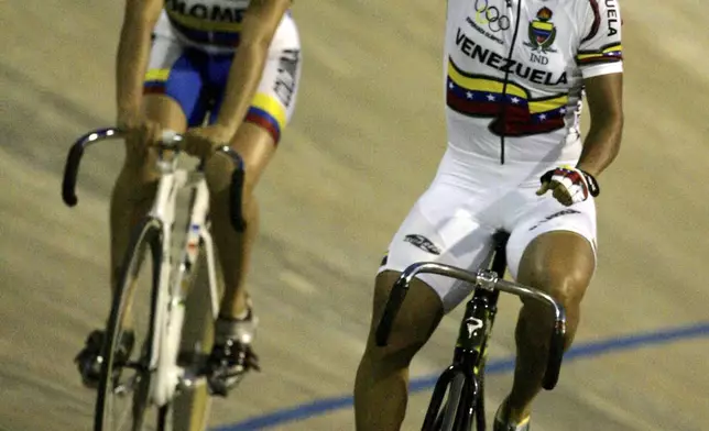 FILE - Venezuela's Daniela Larreal Chirinos, right, reacts after winning the gold medal in the sprint event of the cycling competition of the Odesur games in Mar del Plata, Argentina, Tuesday, Nov. 14, 2006, chased by Colombia's Diana Garcia Orrego who won the silver medal. (AP Photo/Eduardo Di Baia, File)