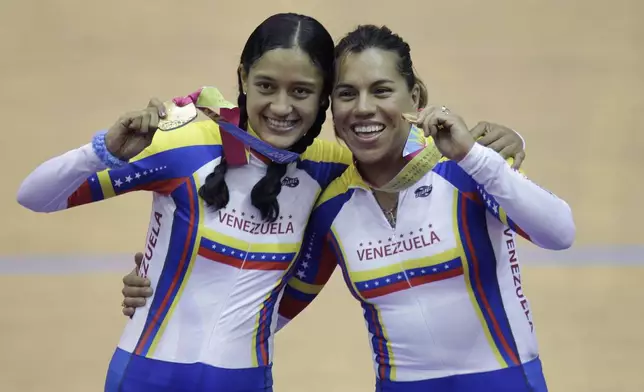 FILE - Venezuela's Mariestela Vilera, left, and Daniela Larreal celebrate after won gold medal in a cycling women's team pursuit final at Pan American Games in Guadalajara, Mexico, Monday, Oct. 17, 2011.(AP Photo/Jorge Saenz, File)