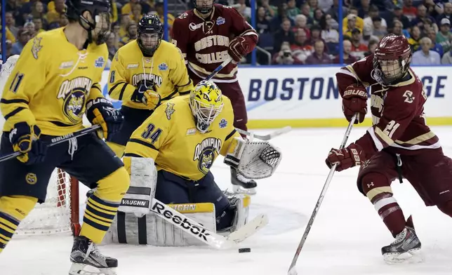 FILE - Quinnipiac goalie Michael Garteig (34) makes the save on a shot by Boston College forward Matthew Gaudreau (21) during the first period of an NCAA Frozen Four semifinal NCAA college hockey game Thursday, April 7, 2016, in Tampa, Fla. (AP Photo/Chris O'Meara, File)