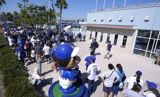 Fans line up to enter and get a bobblehead of Los Angeles Dodgers' Shohei Ohtani prior to a baseball game between the Dodgers and the Baltimore Orioles Thursday, Aug. 29, 2024, in Los Angeles. (AP Photo/Mark J. Terrill)