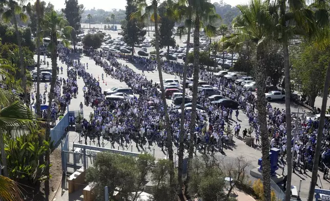 Fans line up to enter and get a bobblehead of Los Angeles Dodgers' Shohei Ohtani prior to a baseball game between the Dodgers and the Baltimore Orioles Thursday, Aug. 29, 2024, in Los Angeles. (AP Photo/Mark J. Terrill)