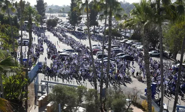 Fans line up to enter and get a bobblehead of Los Angeles Dodgers' Shohei Ohtani prior to a baseball game between the Dodgers and the Baltimore Orioles, Wednesday, Aug. 28, 2024, in Los Angeles. (AP Photo/Mark J. Terrill)