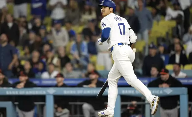 Los Angeles Dodgers' Shohei Ohtani heads to first as he flies out during the eighth inning of a baseball game against the Baltimore Orioles Thursday, Aug. 29, 2024, in Los Angeles. (AP Photo/Mark J. Terrill)