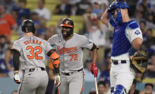 Baltimore Orioles' Ryan O'Hearn, left, celebrates his solo home run with Eloy Jiménez (72) during the second inning of a baseball game against the Los Angeles Dodgers, Tuesday, Aug. 27, 2024, in Los Angeles. (AP Photo/Marcio Jose Sanchez)