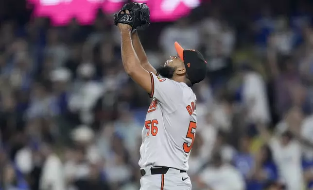 Baltimore Orioles relief pitcher Seranthony Domínguez celebrates after the last out of a baseball game against the Los Angeles Dodgers, Tuesday, Aug. 27, 2024, in Los Angeles. (AP Photo/Marcio Jose Sanchez)