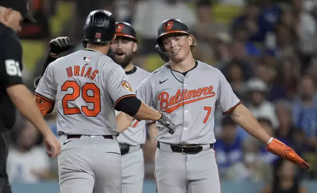 Baltimore Orioles' Ramón Urías (29) celebrates his solo home run with Jackson Holliday (7) during the fifth inning of a baseball game against the Los Angeles Dodgers, Tuesday, Aug. 27, 2024, in Los Angeles. (AP Photo/Marcio Jose Sanchez)