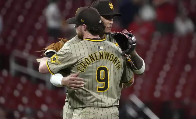 San Diego Padres' Manny Machado and teammate Jake Cronenworth (9) celebrate a 7-4 victory over the St. Louis Cardinals in a baseball game Monday, Aug. 26, 2024, in St. Louis. (AP Photo/Jeff Roberson)