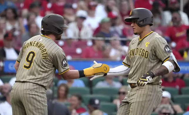 San Diego Padres' Manny Machado is congratulated by teammate Jake Cronenworth (9) after hitting a two-run home run during the first inning of a baseball game against the St. Louis Cardinals Monday, Aug. 26, 2024, in St. Louis. (AP Photo/Jeff Roberson)