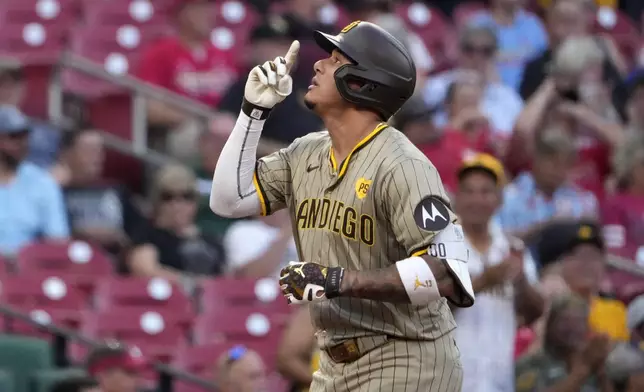 San Diego Padres' Manny Machado arrives home after hitting a two-run home run during the first inning of a baseball game against the St. Louis Cardinals Monday, Aug. 26, 2024, in St. Louis. (AP Photo/Jeff Roberson)