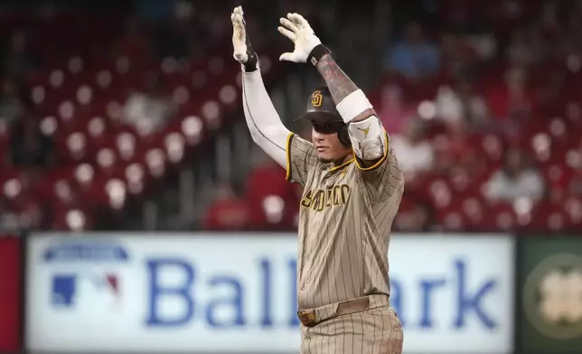 San Diego Padres' Manny Machado celebrates after hitting an RBI double during the fifth inning of a baseball game against the St. Louis Cardinals Monday, Aug. 26, 2024, in St. Louis. (AP Photo/Jeff Roberson)