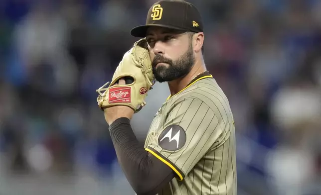 San Diego Padres starting pitcher Matt Waldron reacts after giving up back-to-back singles to Miami Marlins' Jake Burger and Jesus Sanchez during the third inning of a baseball game, Saturday, Aug. 10, 2024, in Miami. (AP Photo/Lynne Sladky)