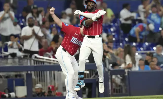 Miami Marlins' Vidal Brujan celebrates as he rounds third base after hitting a solo home run during the third inning of a baseball game against the San Diego Padres, Saturday, Aug. 10, 2024, in Miami. (AP Photo/Lynne Sladky)