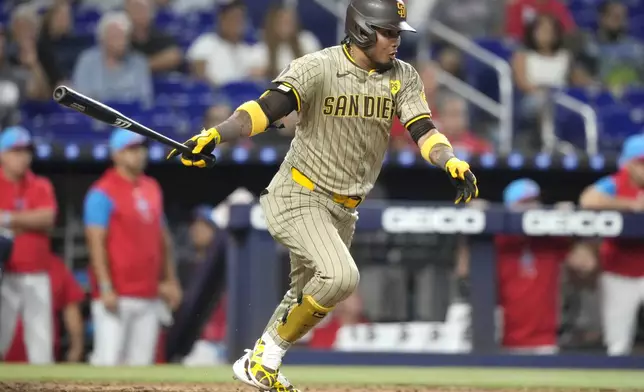 San Diego Padres' Luis Arraez follows through on a single to score Bryce Johnson during the eighth inning of a baseball game against the Miami Marlins, Saturday, Aug. 10, 2024, in Miami. (AP Photo/Lynne Sladky)