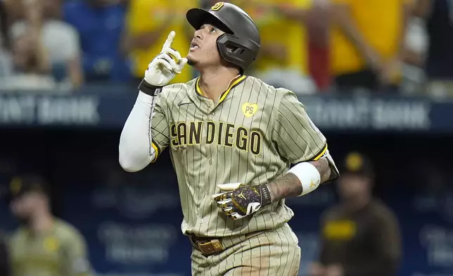 San Diego Padres' Manny Machado celebrates his three-run home run off Tampa Bay Rays starting pitcher Taj Bradley during the second inning of a baseball game Friday, Aug. 30, 2024, in St. Petersburg, Fla. (AP Photo/Chris O'Meara)