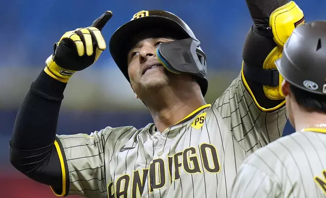 San Diego Padres' Donovan Solano, left, celebates his two-run single off Tampa Bay Rays relief pitcher Garrett Cleavinger with first base coach, outfield &amp; base running instructor David Macias during the ninth inning of a baseball game Friday, Aug. 30, 2024, in St. Petersburg, Fla. (AP Photo/Chris O'Meara)