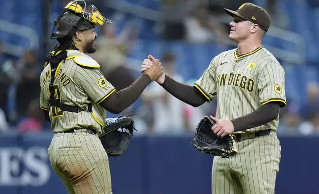 San Diego Padres relief pitcher Adrian Morejon celebrates with catcher Luis Campusano after closing out the Tampa Bay Rays during the ninth inning of a baseball game Friday, Aug. 30, 2024, in St. Petersburg, Fla. (AP Photo/Chris O'Meara)