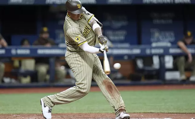 San Diego Padres' Manny Machado lines a single off Tampa Bay Rays relief pitcher Richard Lovelady during the sixth inning of a baseball game Friday, Aug. 30, 2024, in St. Petersburg, Fla. (AP Photo/Chris O'Meara)