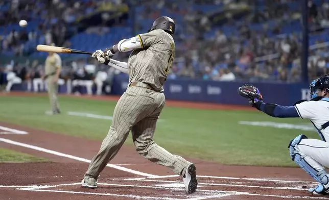 San Diego Padres' Manny Machado connects for an RBI single off Tampa Bay Rays starting pitcher Taj Bradley during the first inning of a baseball game Friday, Aug. 30, 2024, in St. Petersburg, Fla. (AP Photo/Chris O'Meara)