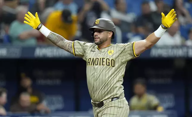 San Diego Padres' David Peralta celebrates his two-run home run off Tampa Bay Rays relief pitcher Erasmo Ramirez during the fourth inning of a baseball game Friday, Aug. 30, 2024, in St. Petersburg, Fla. (AP Photo/Chris O'Meara)