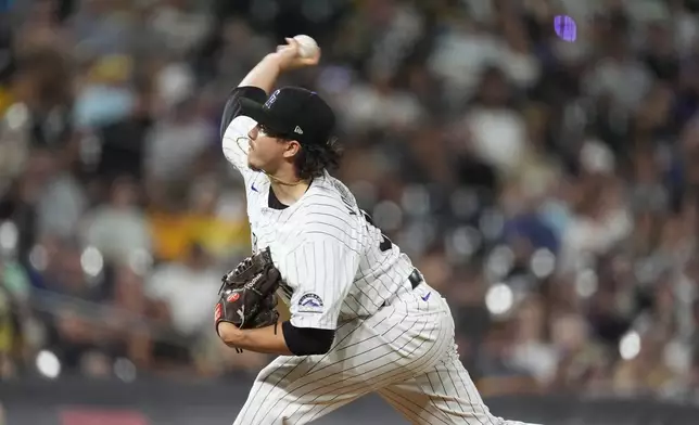 Colorado Rockies relief pitcher Victor Vodnik works against the San Diego Padres in the ninth inning of a baseball game Friday, Aug. 16, 2024, in Denver. (AP Photo/David Zalubowski)