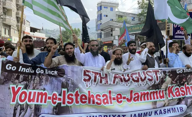 Supporters Pasban-e-Hurriyat Jammu Kashmir, chant slogans during a protest to show solidarity with the Kashmiri people on the eve of the fifth anniversary of India's decision to strip the disputed region of its semi-autonomy, in Muzaffarabad, Pakistan, Monday, Aug. 5, 2024. (AP Photo/M.D. Mughal)