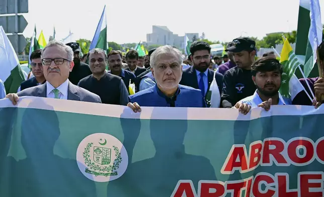 In this photo released by the Pakistan Foreign Ministry, Pakistani officials take part in a rally to show solidarity with the Kashmiri people on the eve of the fifth anniversary of India's decision to strip the disputed region of its semi-autonomy, in Islamabad, Pakistan, Monday, Aug. 5, 2024. (Pakistan Foreign Ministry via AP)