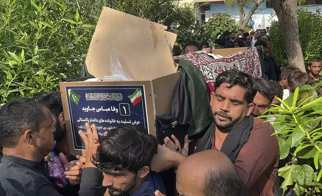 People carry the casket of a Shiite Muslim pilgrim who was killed in the bus crash in Iran while heading to Iraq for a pilgrimage, during a funeral in Larkana, Pakistan, Saturday, Aug. 24, 2024. (AP Photo/Muhammad Usama)