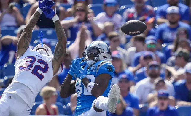 Carolina Panthers wide receiver Terrace Marshall Jr. and Buffalo Bills cornerback Kyron Brown (32) leap for a pass in the second half of an NFL preseason football game, Saturday, Aug. 24, 2024, in Orchard Park, N.Y. (AP Photo/Charles Krupa)