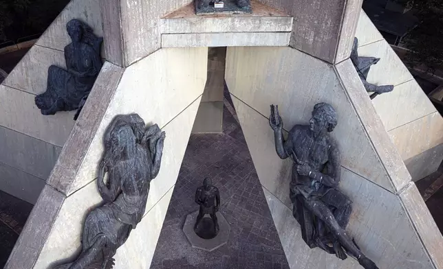 The feet, top, are what remains of a statue of former dictator Gen. Alfredo Stroessner (1912-2006) that was removed several decades ago from Victory Peace Monument which features national heroes on Lambare Hill in Asuncion, Paraguay, Wednesday, Aug. 14, 2024, the day before the 70th anniversary of the start of Stroessner's regime that lasted 35 years. (AP Photo/Jorge Saenz)