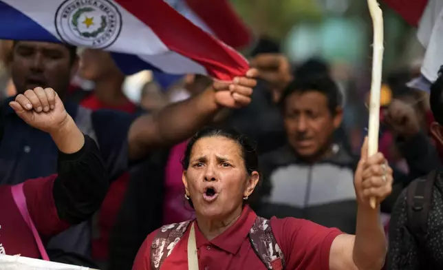 Anti-government protesters march during an opposition rally, marking a year since President Santiago Pena's inauguration, in Asuncion, Paraguay, Thursday, Aug. 15, 2024. (AP Photo/Jorge Saenz)