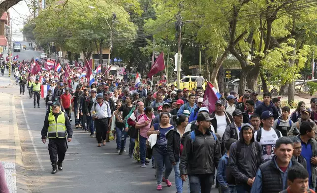 Anti-government protesters march during an opposition rally, marking a year since President Santiago Pena's inauguration, in Asuncion, Paraguay, Thursday, Aug. 15, 2024. (AP Photo/Jorge Saenz)