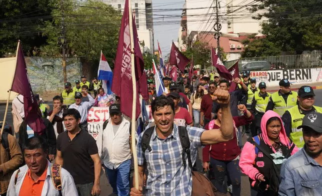 Anti-government protesters march during an opposition rally, marking a year since President Santiago Pena's inauguration, in Asuncion, Paraguay, Thursday, Aug. 15, 2024. (AP Photo/Jorge Saenz)