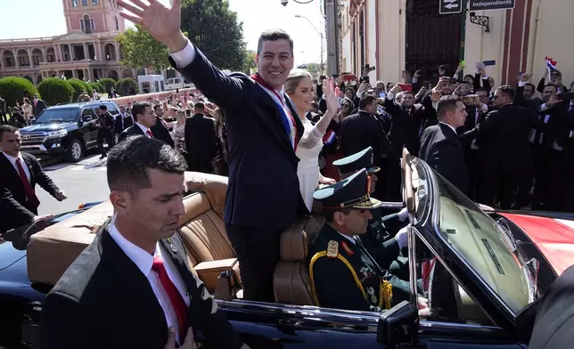 FILE - Paraguay's newly sworn-in President Santiago Pena and first lady Leticia Ocampos wave as they are transported to the Cathedral, on his inauguration day, in Asuncion, Paraguay, Aug. 15, 2023. (AP Photo/Jorge Saenz, File)