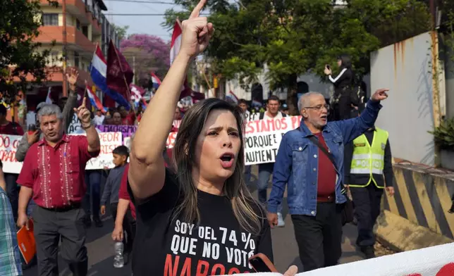 Kattya González, a popular senator and vocal government critic who was booted from the Senate last February, marches in an opposition rally, marking a year since President Santiago Pena's inauguration, in Asuncion, Paraguay, Thursday, Aug. 15, 2024. (AP Photo/Jorge Saenz)