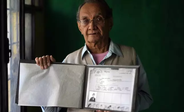 Emilio Barreto, 84, who was political prisoner for 13 years during the dictatorship of Gen. Alfredo Stroessner, holds a copy of a police document from his time in prison, during an interview at his home in Lambare, Paraguay, Wednesday, Aug. 14, 2024. (AP Photo/Jorge Saenz)