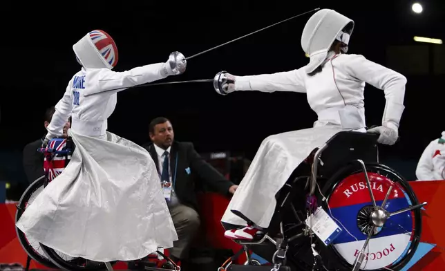 Great Britain's Justine Moore, left, competes against Russia's Liudmila Vasileva during the Paralympic women's individual Epee Category B Preliminary Pool B at the Excel Arena, London, Sept. 5, 2012. (AP Photo/John Walton, PA)