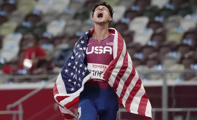 United States' Nick Mayhugh celebrates after winning the men's 100m T37 final at Tokyo 2020 Paralympic Games, Aug. 27, 2021, in Tokyo, Japan. (AP Photo/Eugene Hoshiko)