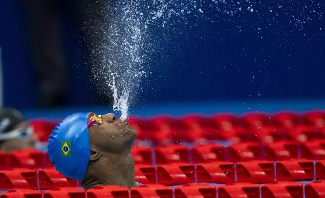 Gabriel Geraldo do Santos Araujo, from Brazil, celebrates his silver medal at Men's 100m Backstroke - S2 Final at the Tokyo Aquatics Centre during the Tokyo 2020 Paralympic Games, Aug. 25, 2021, in Tokyo, Japan. (AP Photo/Emilio Morenatti)