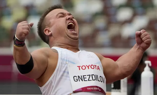 Denis Gnezdilov of the Russian Paralympic Committee reacts after winning the men's F40 shot put final during the 2020 Paralympics at the National Stadium in Tokyo, Aug. 29, 2021. (AP Photo/Eugene Hoshiko)