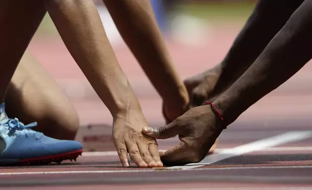 Melissa Baldera of Peru is assisted by her guide at the starting line during the women's 400m T11 at the Tokyo 2020 Paralympics Games in Tokyo, Japan, Aug. 27, 2021. (AP Photo/Eugene Hoshiko)