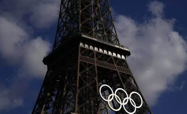 The Olympic rings are seen on the Eiffel Tower during the 2024 Summer Olympics, Tuesday, Aug. 6, 2024, in Paris, France. (AP Photo/Charlie Riedel)