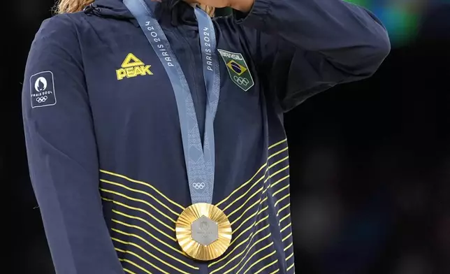 Rebeca Andrade, of Brazil, celebrates after winning the gold medal during the women's artistic gymnastics individual floor finals at Bercy Arena at the 2024 Summer Olympics, Monday, Aug. 5, 2024, in Paris, France. (AP Photo/Abbie Parr)